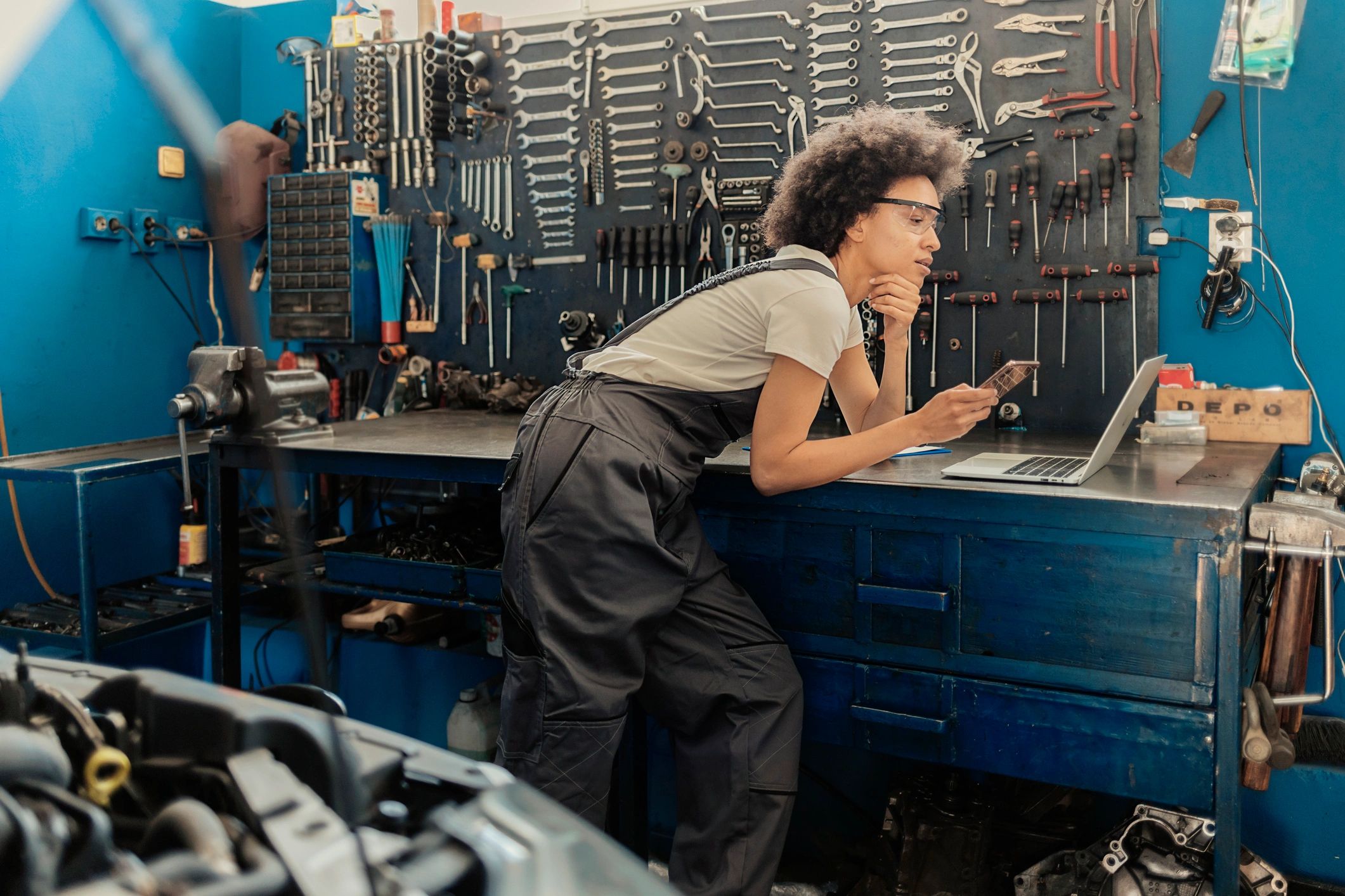 Service advisor using a phone in an auto repair shop