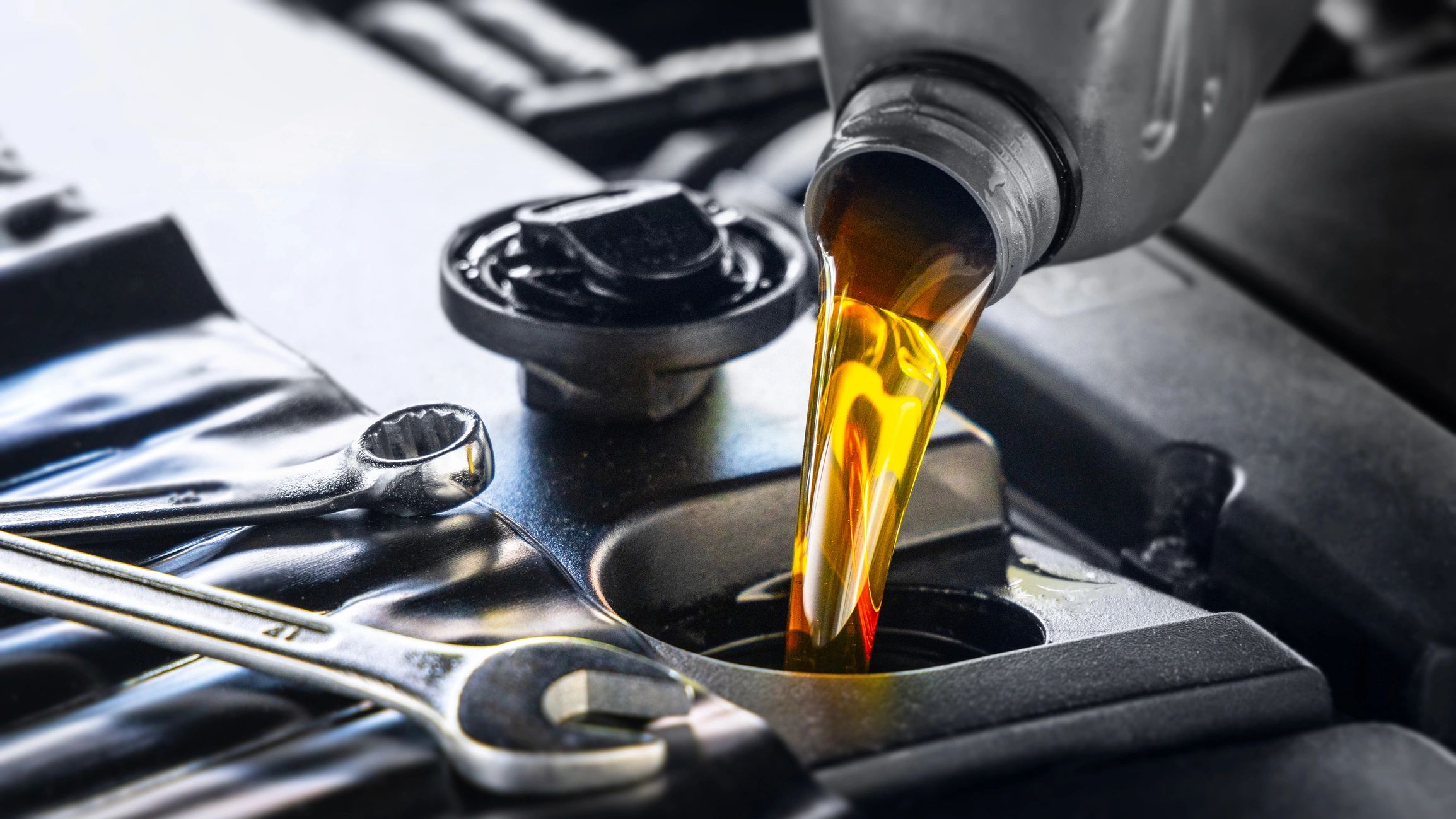 Pouring motor oil into an engine during service