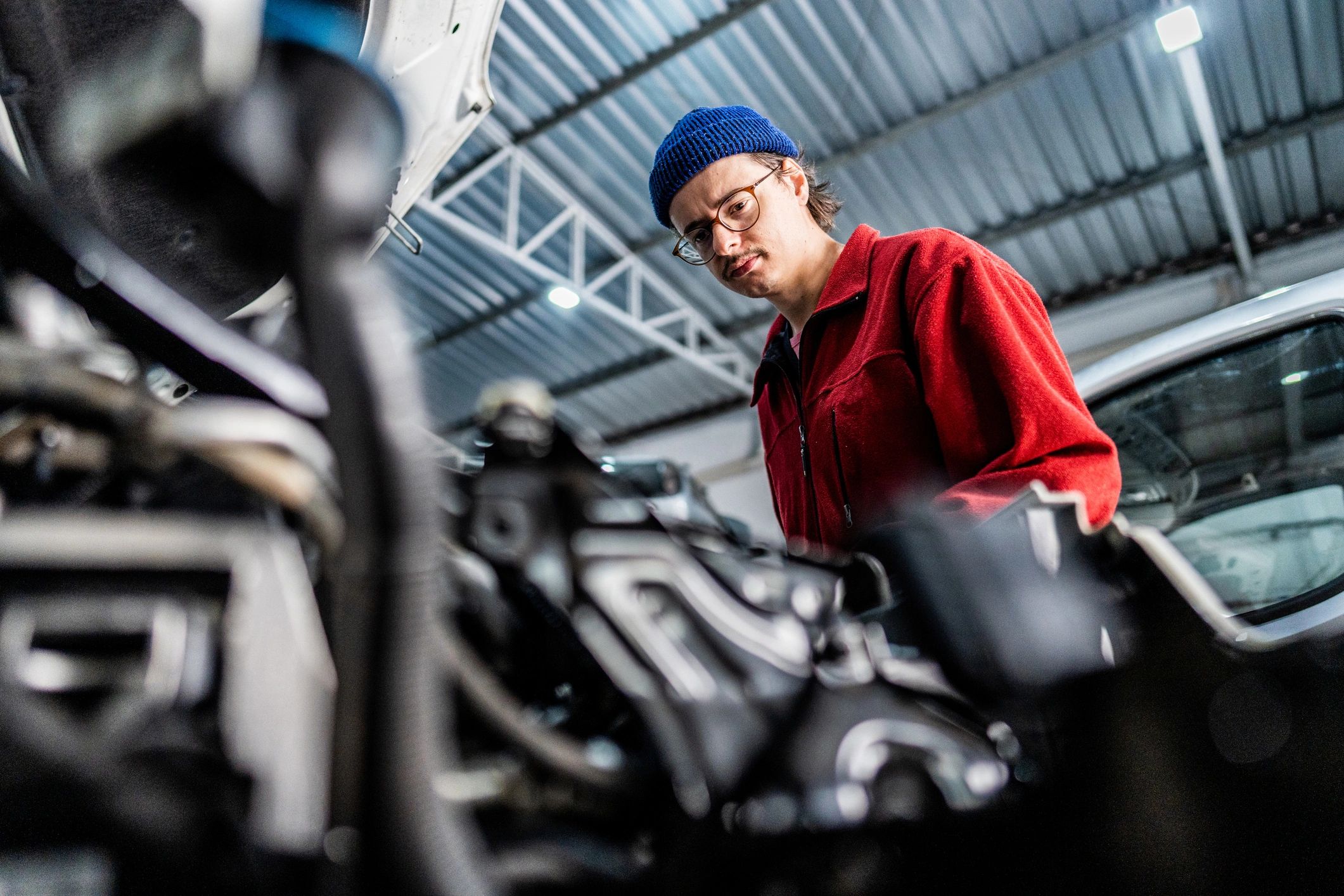 ASE-certified mechanic inspecting a vehicle during routine maintenance