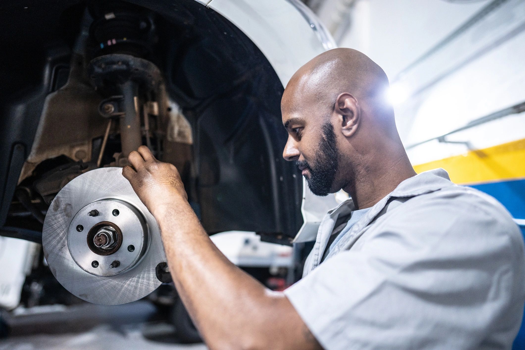 Technician inspecting a brake rotor during service