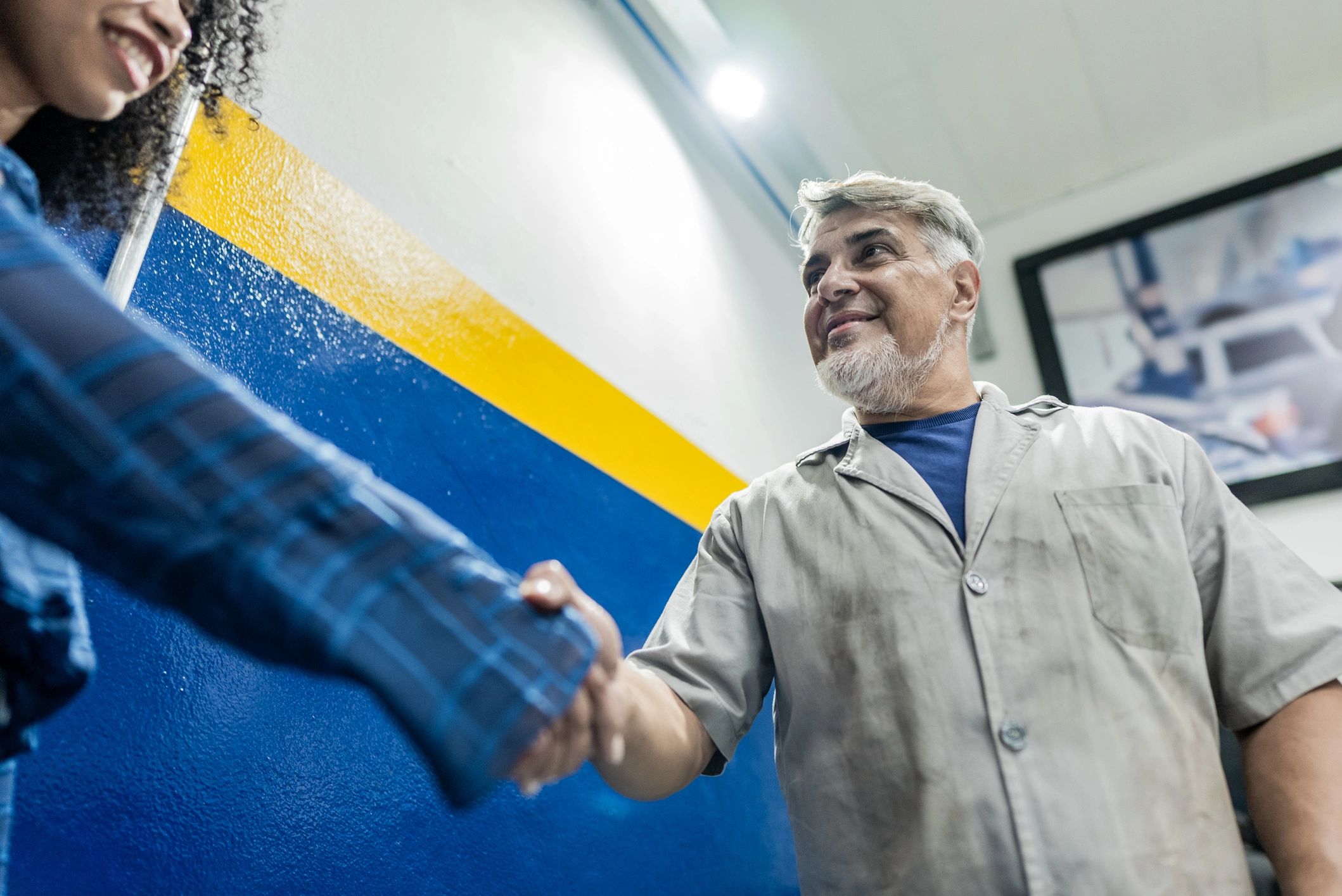 Service advisor greeting a customer at an auto repair shop