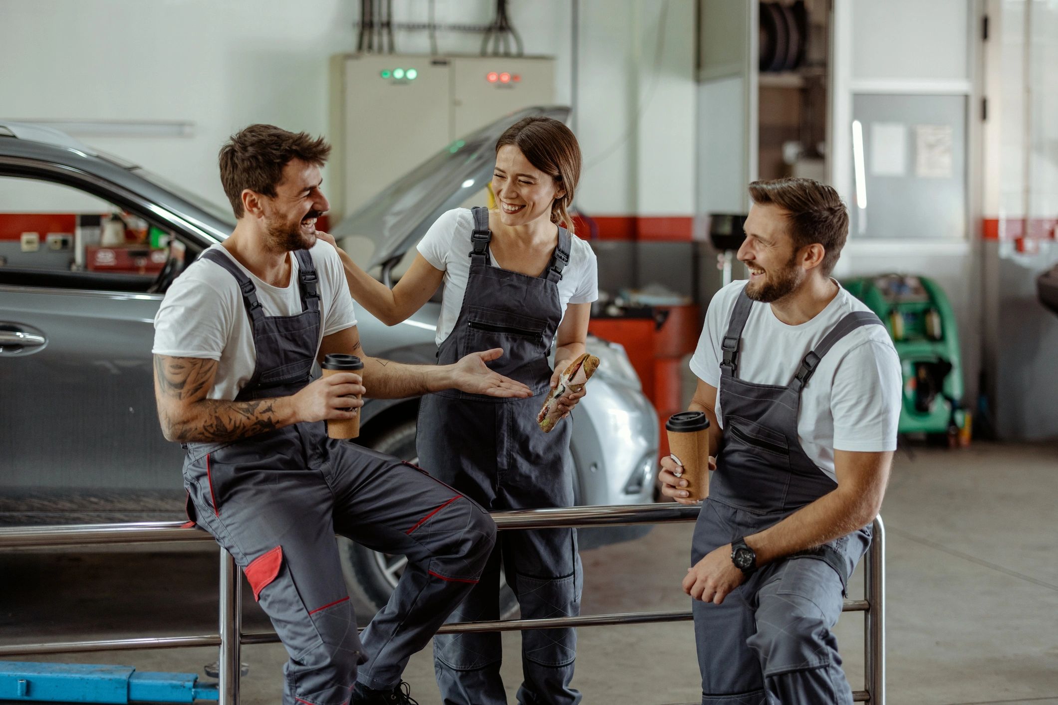 Service center staff sharing a quick break in the workshop