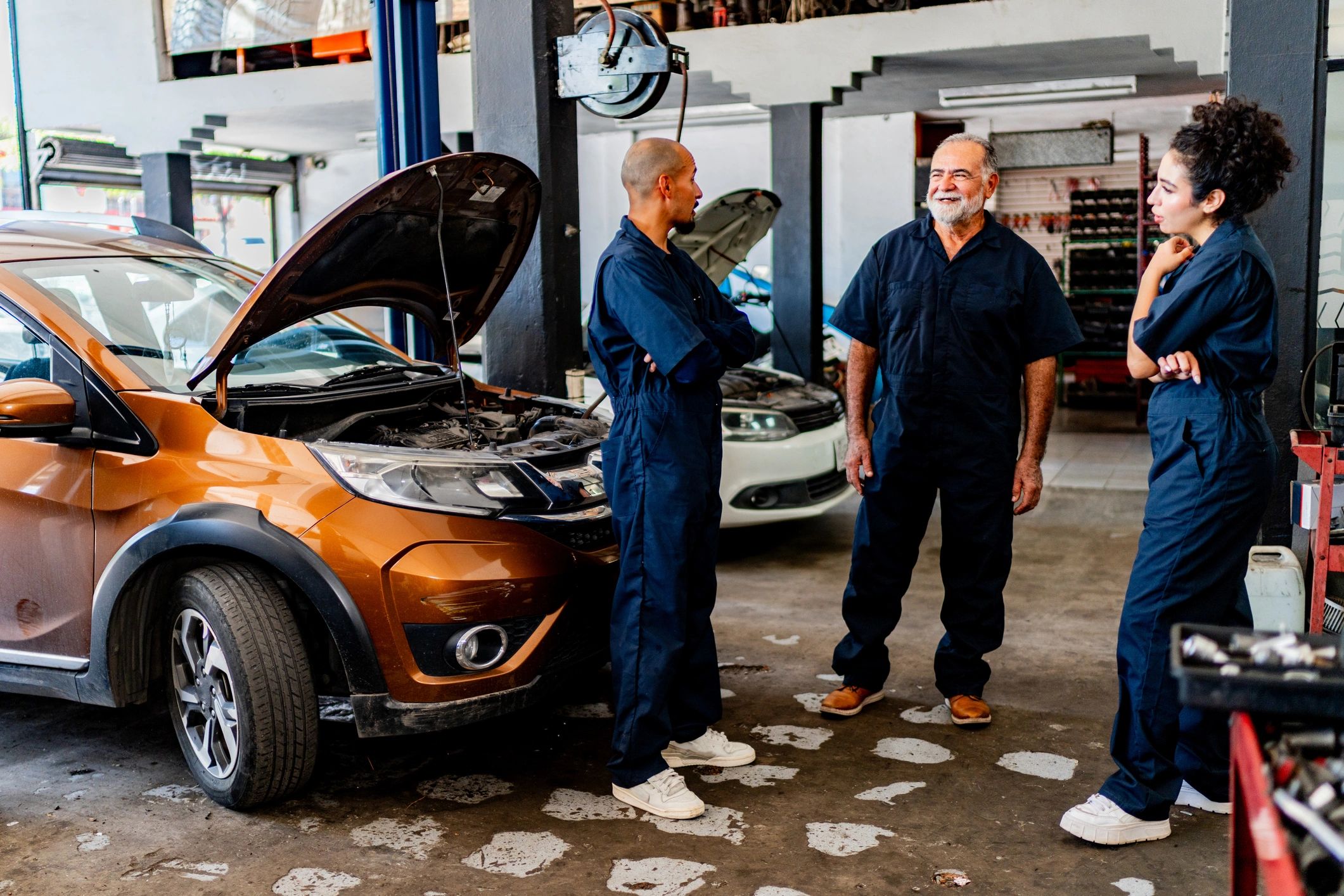 Technicians discussing a repair plan in the shop
