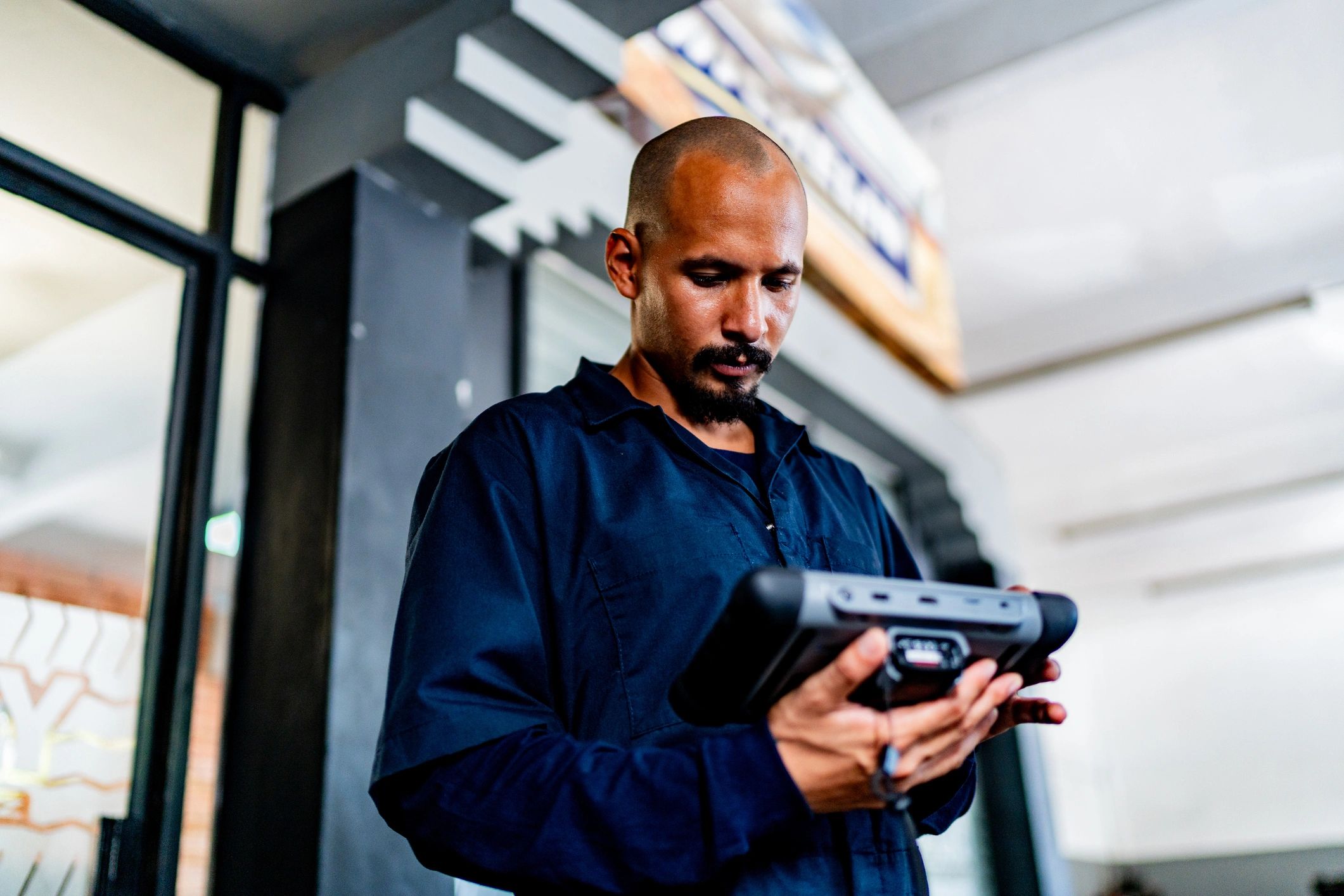 Mechanic performing diagnostics with a scan tool in a repair bay