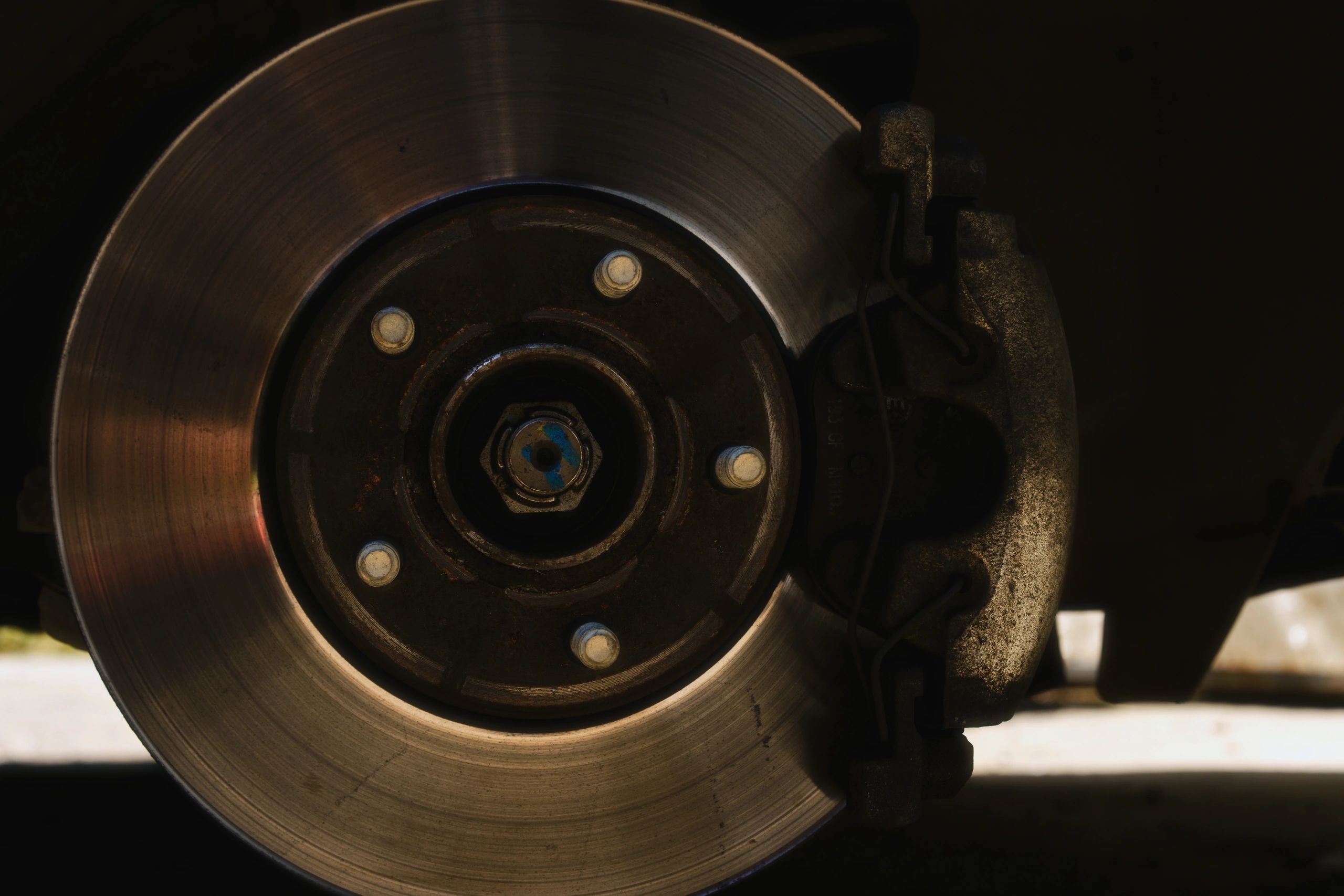 Close-up of brake disc and caliper during vehicle maintenance
